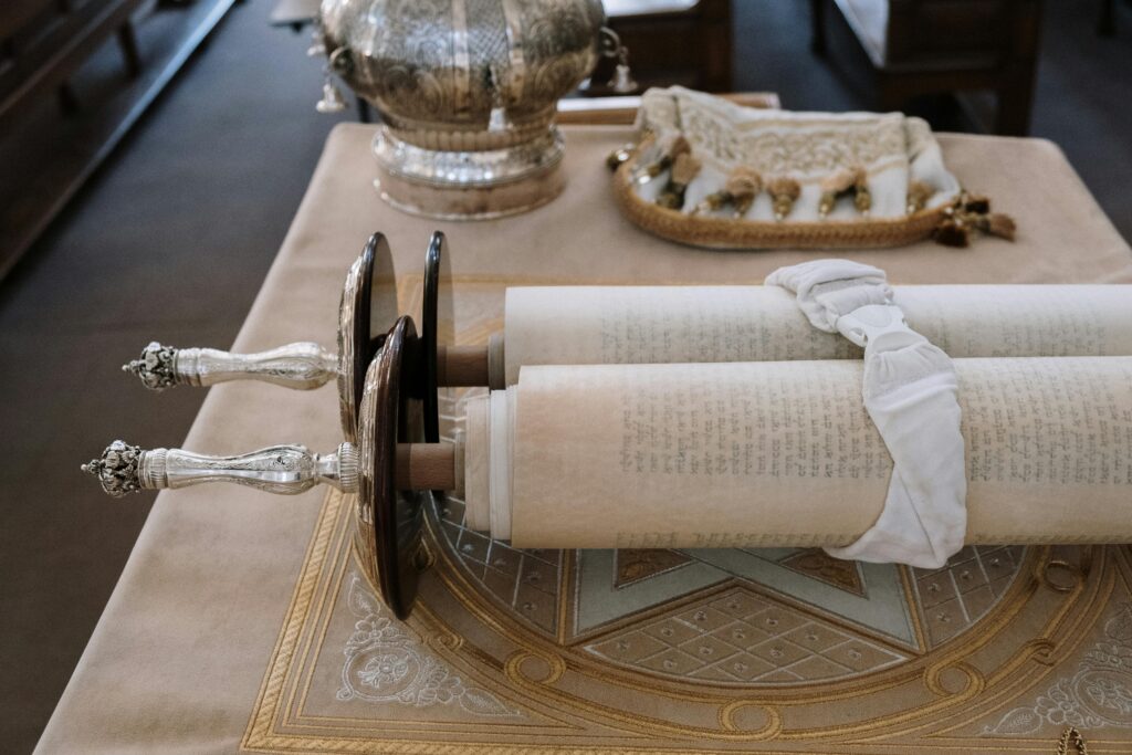Sefer Torah scroll displayed on a bimah in a synagogue setting, showcasing rich cultural heritage.
